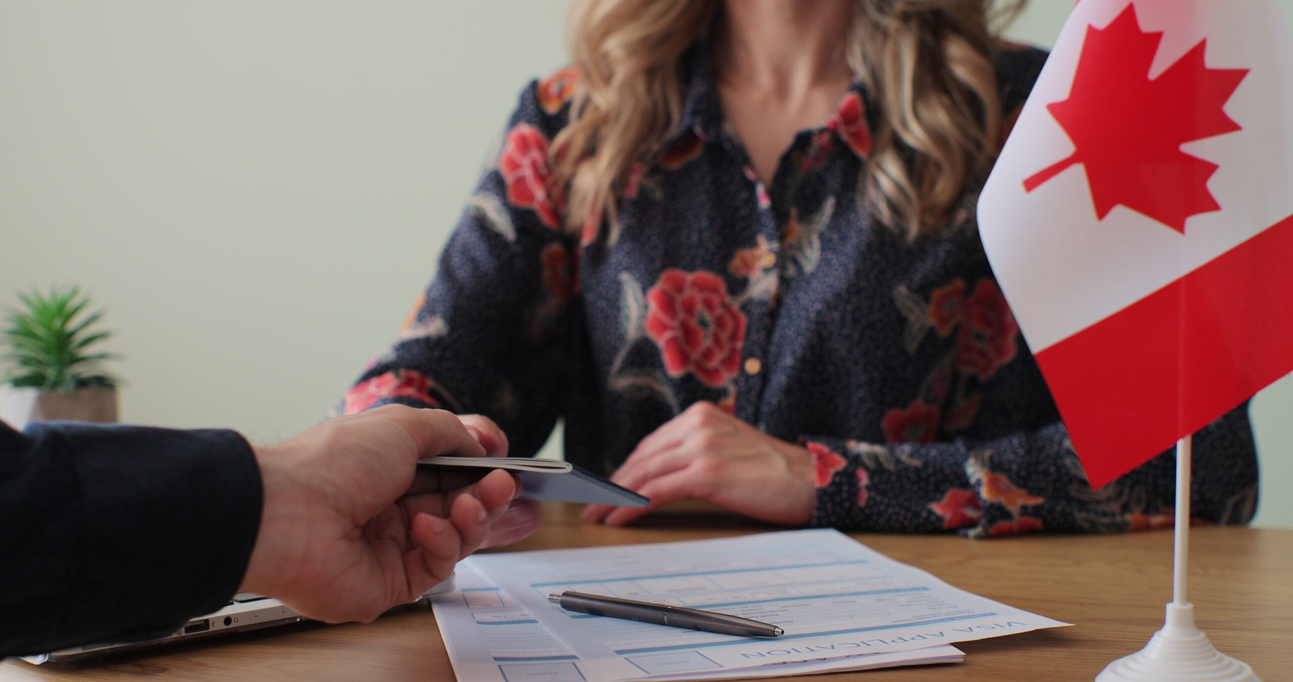 Canadian woman consular officer giving passport to male immigrant, work visa, citizenship. Visa Application online form immigration concept. Visa approval. Canadian woman consular officer giving passport to male immigrant, work visa, citizenship. Visa Application online form immigration concept. Visa approval